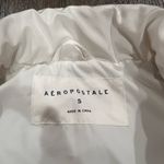 Aeropostale Stay warm and stylish with this sleek white puffer vest. Perfect for layering in cooler weather. Photo 1