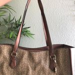 GUESS brown and tan tote monogram hand shoulder bag purse. Some wear as pictured. Great for work school college university. Can fit most books laptops. Photo 2