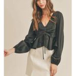 All in Favor black " Tie Front Satin Peplum Top" with a V-neck and long sleeves. Photo 1