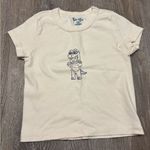 Brandy Melville  ashlyn cream baby tee with baby dinosaur costume graphic Photo 0