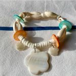 painted seashell and puka shell bracelet with charms Photo 2