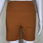 We Wore What ‎ Nylon Biker Short in Gold Photo 1