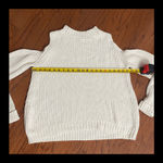 Jennifer Lopez Cream long sleeve cable knit open shoulder sweater- size Large. ***refer to measurement. Gently warn and excellent condition. Measurements approximately 21” from armpit to armpit x 22”. None smoking home. Priced at as is condition. Don’t like my price make a reasonable offer! And thank you for checking my closet! Photo 6