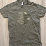 Cannes Film Festival (Festival de Cannes) green and cream t shirt Photo 0