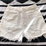 Mid/High waisted white denim shorts with frayed hem and raw hem, zipper and button closure. Size XS Photo 0