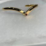 Avon gold tone V shaped cuff bracelet with faux ruby or garnet. Large Photo 2