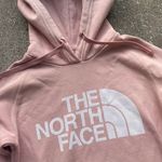 The North Face Hoodie Women’s Size XS Shade of Light Pink Has/Shows Wear, but still in good used condition overall Has all-over pilling/fuzzies Photo 2