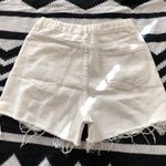 Mid/High waisted white denim shorts with frayed hem and raw hem, zipper and button closure. Size XS Photo 1