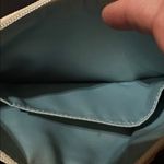 Coach  Poppy Woodmark Multicolor Text Wristlet with Teal Accents. Photo 10