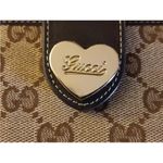 Gucci •  gold heart canvas and leather bifold wallet Photo 1