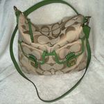 Coach  hobo-style crossbody purse, beige signature with green leather trim. Photo 1