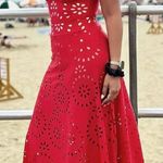 Ellison Stand out in this vibrant red maxi dress. Features stylish cutout patterns. Perfect for beach outings or summer events. Photo 0