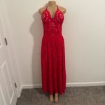 Ellison Stand out in this vibrant red maxi dress. Features stylish cutout patterns. Perfect for beach outings or summer events. Photo 2