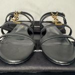 Saint Laurent CASSANDRA LEATHER WITH GOLD EMBLEM HARDWARE IN BLACK SANDALS. Photo 4