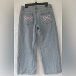 Edikted  PacSun light wash mid rise wide-leg jeans w/ pink bows; size M Photo 5
