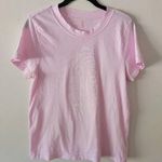 Free People Movement Super cute free people top it’s very worn. The pink is kind of washed out in the photo but not really in person. Photo 0