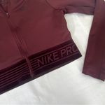 Nike  cropped maroon zip up longsleeve size women’s medium Photo 1