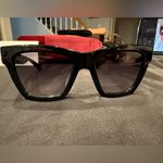 Gucci GG1714S cat-eye sunglasses with a black frame and solid grey lenses Photo 11