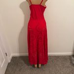 Ellison Stand out in this vibrant red maxi dress. Features stylish cutout patterns. Perfect for beach outings or summer events. Photo 6