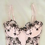 Victoria's Secret Baby pink coquette ballerina corset top with black floral and bow embroidery and ruffle details Photo 2