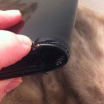 Vintage faux black patent leather clutch with gold trim. Photo 3