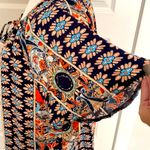 Angashion | Navy/burnt orange print short sleeve scoop neck top with tie accent. Photo 3