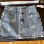 PacSun  new with tags butterfly denim jean skirt in a size 26 Photo 4