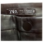 ZARA -BLACK FAUX LEATHER PANTS-SIZE XS Gorgeous black faux leather pants, side zipper, zips at ankles, excellent condition Measurements: Waist: side to side 13 Rise: 11 inches Inseam: 27 inches Photo 2