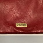 Carlos Santana  burgundy clutch Photo 2