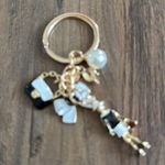 Elegant Gold and Black Keychain with Charms Photo 3
