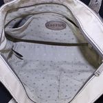 Antique Gold Metallic Pebble Leather Tote Exterior Small Slip Pocket in Back 3 Interior Pockets 1 Zip Zippered Top Closure L 13.75" x W 5" x x H 10.50" Handle Drop 9.5 Photo 3