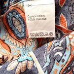 Angashion | Navy/burnt orange print short sleeve scoop neck top with tie accent. Photo 7