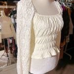 Love, Fire Love Fire Los Angeles cream Ivory peplum peasant top floral lace full lined off shoulder stretchy tie waist New with tag Same day shipping Smoke and pets free Introducing the beautiful Love Fire Los Angeles cream peplum peasant top with a gorgeous floral lace design, fully lined for maximum comfort and stretchy for a perfect fit. This top is perfect for any occasion, whether it's a night out with friends or a day time event. The long sleeves and ivory color give it a sophisticated look, while the angel character and peasant theme add a unique touch. With a regular size type and size S, this blouse will fit most women comfortably. Its features include a fabric type of lace, making it the perfect addition to any wardrobe. This top is ideal for those who want to look trendy and fashionable without sacrificing comfort. Photo 3