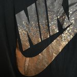 Nike long sleeve black tee with a silver/gold logo size small Photo 2
