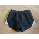 Under Armour  HeatGear Running Shorts Black White Women’s M Medium Loose Fit Photo 3