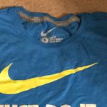 Nike Women’s blue and yellow  shirt Photo 1