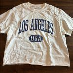 Brandy Melville John Galt Top T-Shirt Cropped White Los Angeles Short Sleeve  Photo 0