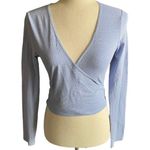 Brandy Melville Beautiful blue with tiny white flowers wrap top, long sleeves, has stretch, excellent condition, size medium Measurements: Bust: armpit to armpit 16 inches Length: shoulder seam to bottom 17 inches Photo 0