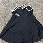 LA Made This chic sundress by Anage features a pleated design in classic black and white, perfect for a casual night out. The sleeveless silhouette with spaghetti straps and a mini length adds a playful touch to your ensemble. Its versatile style makes it a must-have for any wardrobe. Photo 6