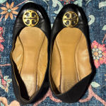 Tory Burch Black and Tan flats with Gold Emblem Photo 0