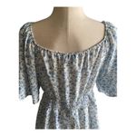 Bloomchic NWT- Adorable white with blue flowers babydoll top, smocked waist, flutter sleeves, brand new, size 14/16 Measurements: Bust: armpit to armpit 21 inches  Waist: side to side 18-24 inches  Length: shoulder seam to bottom 29 inches Photo 3