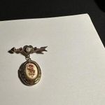 Avon Gold Tone & Rhinestone Brooch Pin Dangling Cupid Locket Photo 1