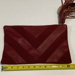 Carlos Santana  burgundy clutch Photo 6