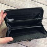 Limited Edition Silver Wristlet Wallet. Good used condition. A few surface flaws. See all pics. Lots of organization pockets/credit card slots. 7” wide x 4” tall Photo 2