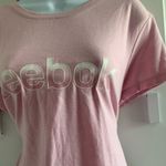Reebok  Women's Soft Pink Tee  Chic and comfy short sleeve tee. Ideal for everyday wear.Small stains shown.  Photo 4