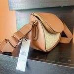 Calvin Klein unique flap camera bag brown vanilla wide soft strap crossbody NWT This crossbody bag is the perfect addition to any outfit. The bag features a unique flap closure with a zipper, magnetic, and snap closure options to ensure the safety of your belongings. The vanilla exterior leather material is accented with a strap accent, zipper, and flap closer, making it both stylish and functional. The bag has a medium size with a width of 11 inches, a height of 8 inches, and a depth of 5 inches. The hardware color is gold, while the handle/strap color is brown, adding a nice contrast to the bag. The bag also comes with an adjustable strap, making it easy to wear across the body. The interior features credit card slots, inner and outer pockets, organizers, and inner dividers, as well as a mobile phone pocket. The bag also comes with a brand card, and its product line is STYLE H4AEJEW4. New in box with tag Same day shipping Smoke and pets free Don’t forget to bundle In My Store Photo 1