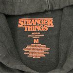 Netflix Stranger Things Spell out Graphic Logo Black Hoodie Sweatshirt Women’s M Photo 3