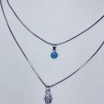 • Silver multi layered evil eye and hand of hamsa necklace set Photo 1