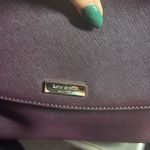 Kate Spade  Laurel Way Lilah satchel in a burgundy or mulberry color. Photo 2