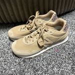 New Balance  515 sneaker in a beige/incense colorway with a leopard print "N" logo and heel tab accent.  Photo 3